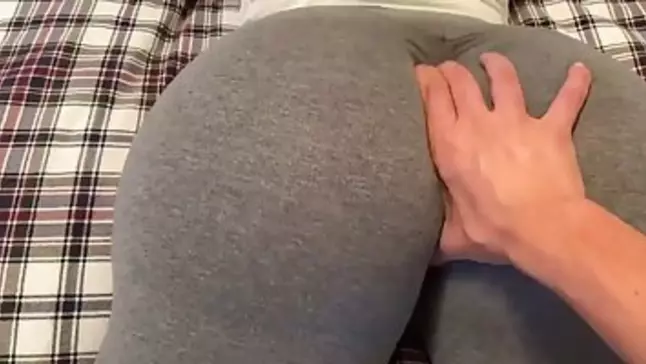 Phat donk brown-haired in yoga trousers is providing a sensuous footjob to one of her pals